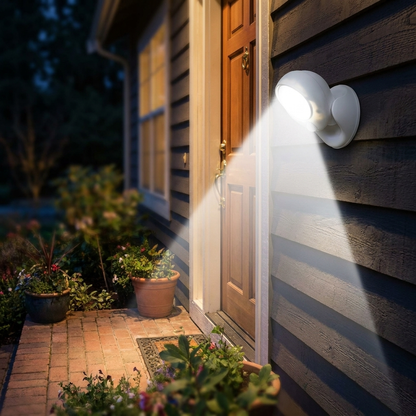 Weatherproof outdoor LED motion light on exterior house wall at night