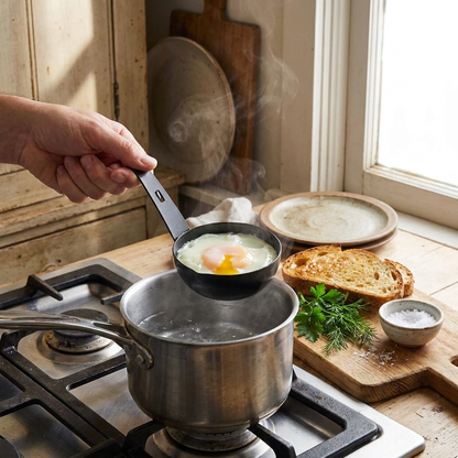 Egg poacher nonstick mold in use on stove